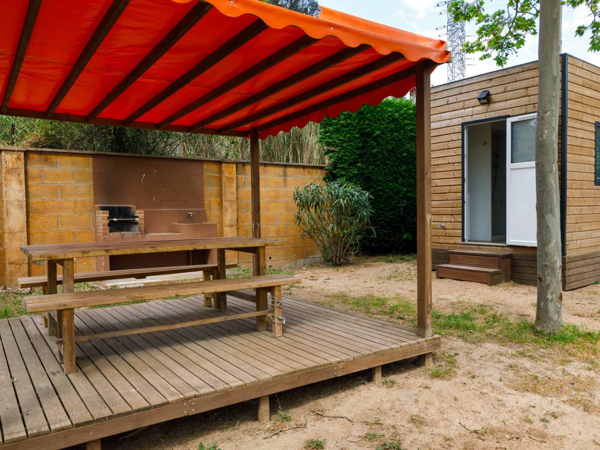 Premium pitch with private sanitary facilities: covered picnic table beside a barbecue