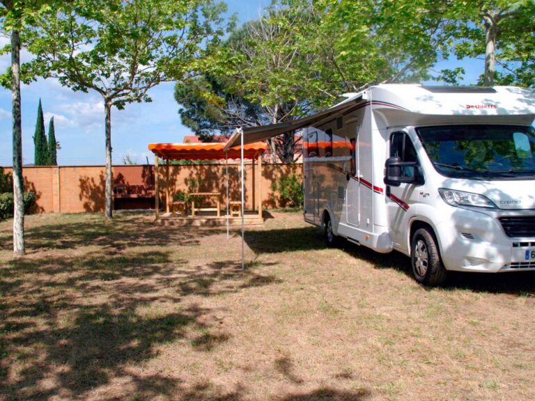 Premium pitch: motorhome beside a covered seating area